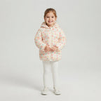 Niña sonriente vistiendo chaqueta acolchada EmpiBy con estampado de conejitos en tonos suaves y capucha