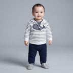 Bebé niño vistiendo conjunto EmpiBy de 3 piezas: chaqueta a rayas con ballena, body y pantalón azul marino.