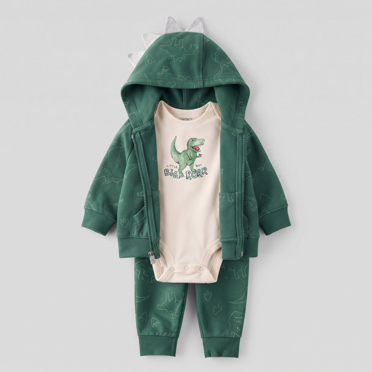 Conjunto EmpiBy de 3 piezas para bebé: chaqueta verde con cresta, body beige con T-Rex y pantalón estampado a juego.