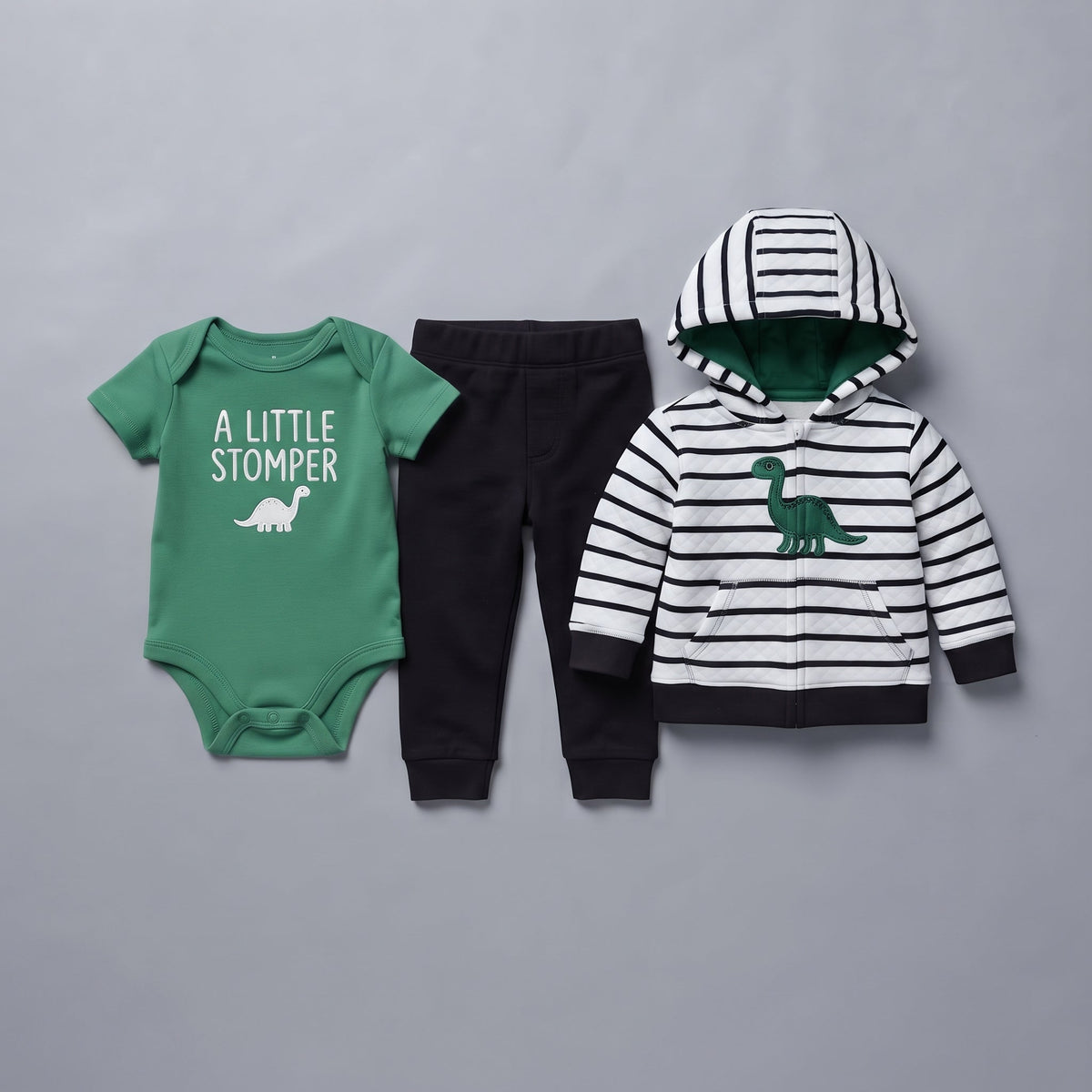 Conjunto EmpiBy de 3 piezas para bebé: body verde, pantalón negro y sudadera a rayas con estampado de dinosaurio.