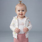 Bebé niña vistiendo conjunto EmpiBy de 3 piezas: chaqueta floral con capucha, body blanco So Happy y legging rosa.