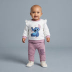 Bebé con conjunto EmpiBy de dos piezas: sudadera blanca con volantes y estampado de Stitch y pantalón jogger malva.