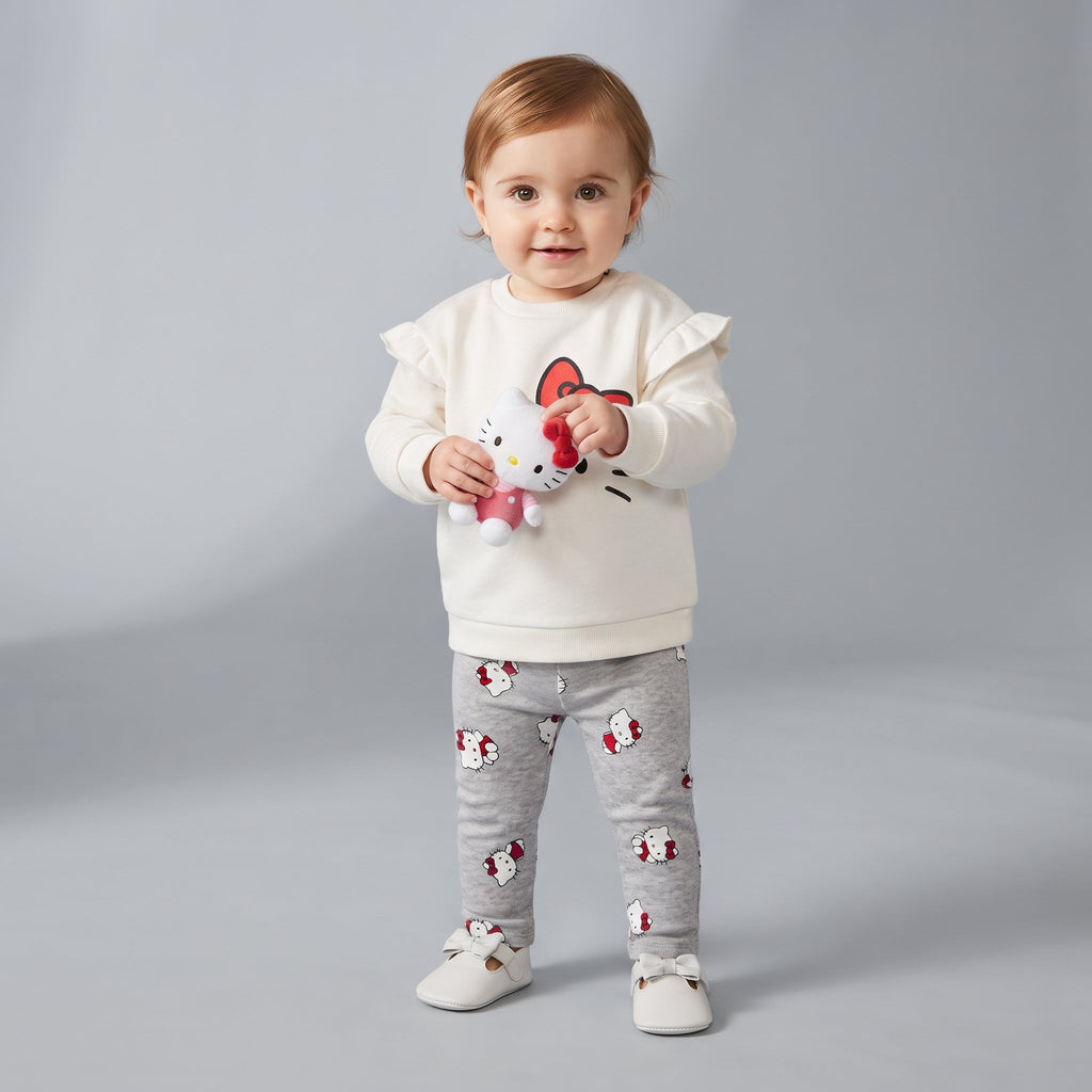 Bebé con conjunto EmpiBy de dos piezas: sudadera marfil con volantes y legging gris estampado de Hello Kitty