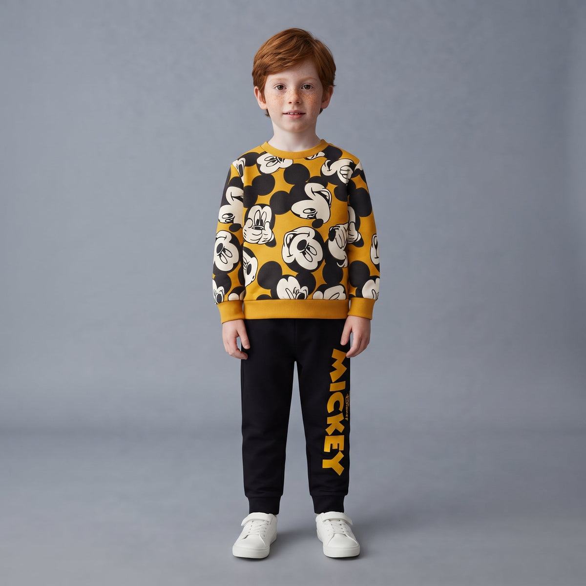 Niño vistiendo conjunto EmpiBy de dos piezas con sudadera estampada de Mickey Mouse y pantalón jogger negro