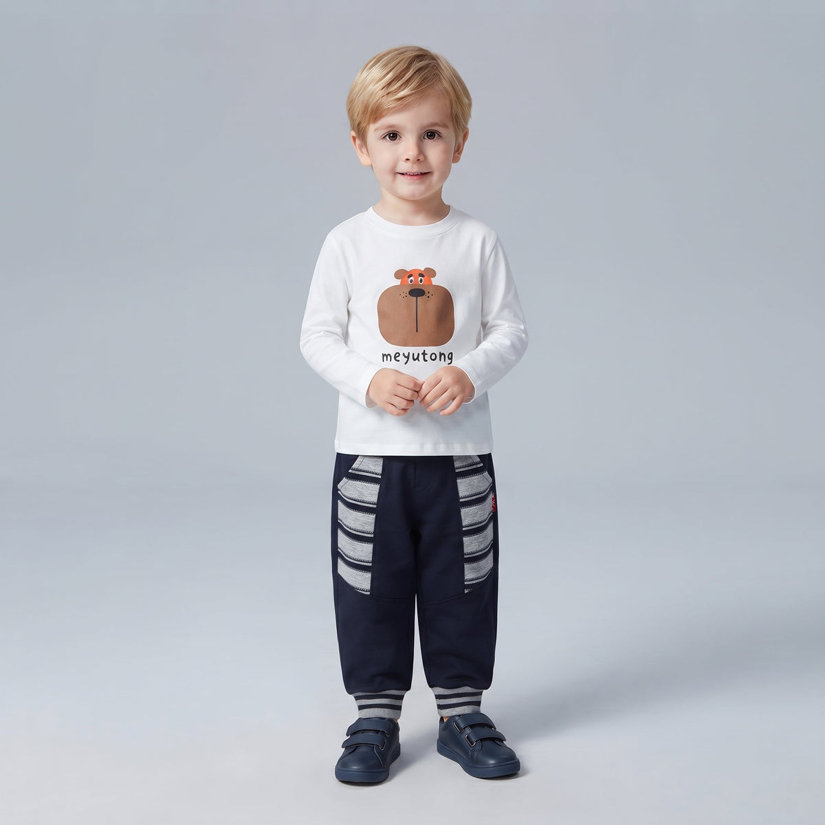 Niño pequeño vistiendo conjunto EmpiBy de camiseta blanca con oso y pantalón azul marino con detalles a rayas