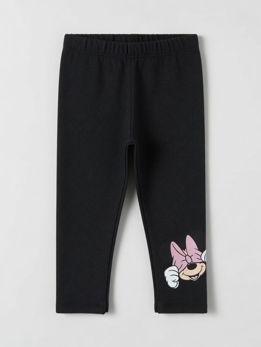 Leggings negros EmpiBy para niña con estampado de Minnie Mouse en la pierna, confeccionados en tela suave y elástica.
