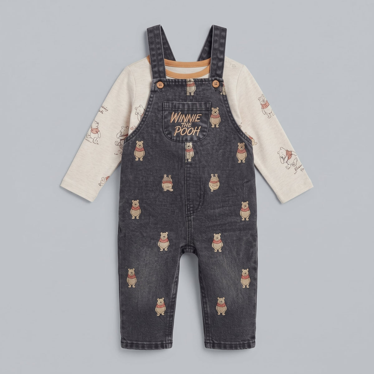 Conjunto EmpiBy de overol de mezclilla oscura con estampado de Winnie Pooh y camiseta beige de manga larga para bebé