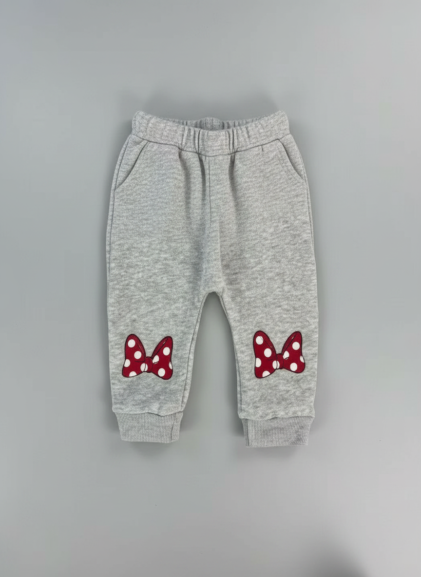 Pantalón jogger gris EmpiBy para niña con lazos rojos de Minnie Mouse estampados en las piernas y cintura elástica