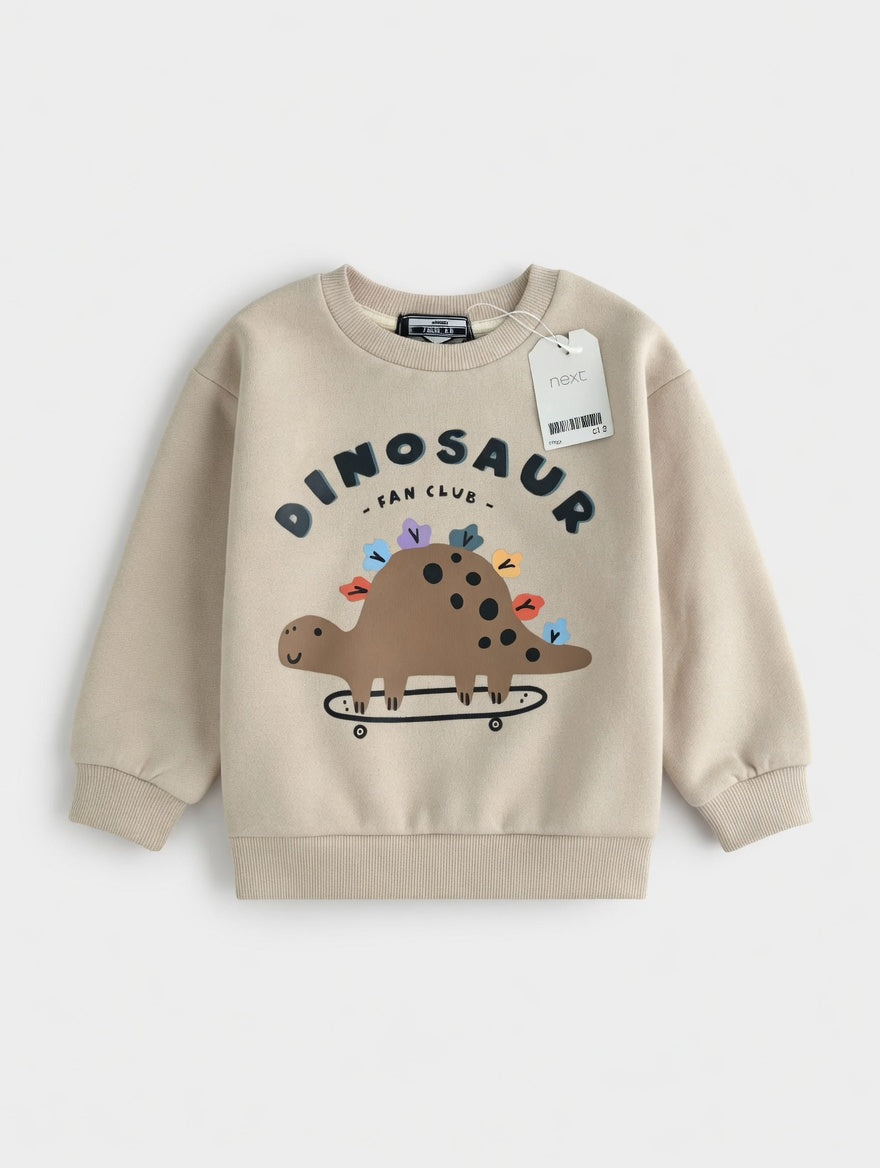 Sudadera EmpiBy de color beige con estampado de dinosaurio en patineta y texto Dinosaur Fan Club para niños