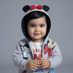 Bebé sonriente con sudadera gris EmpiBy de Minnie Mouse con capucha, orejas y lazo rojo sobre camiseta estampada